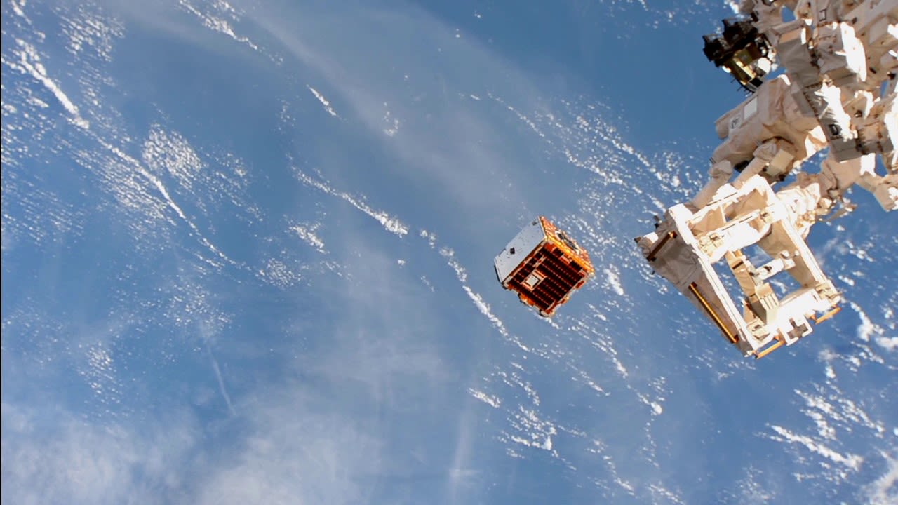 Image of a satellite above the Earth from space