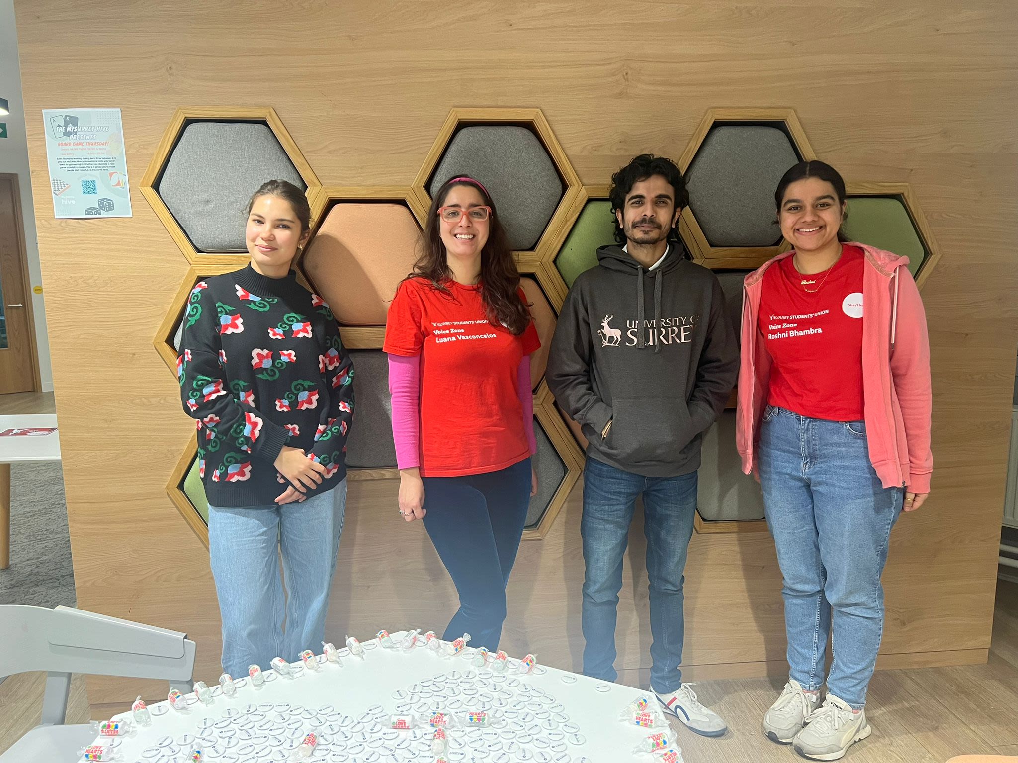 Four students pose for a photo inside MySurrey Hive