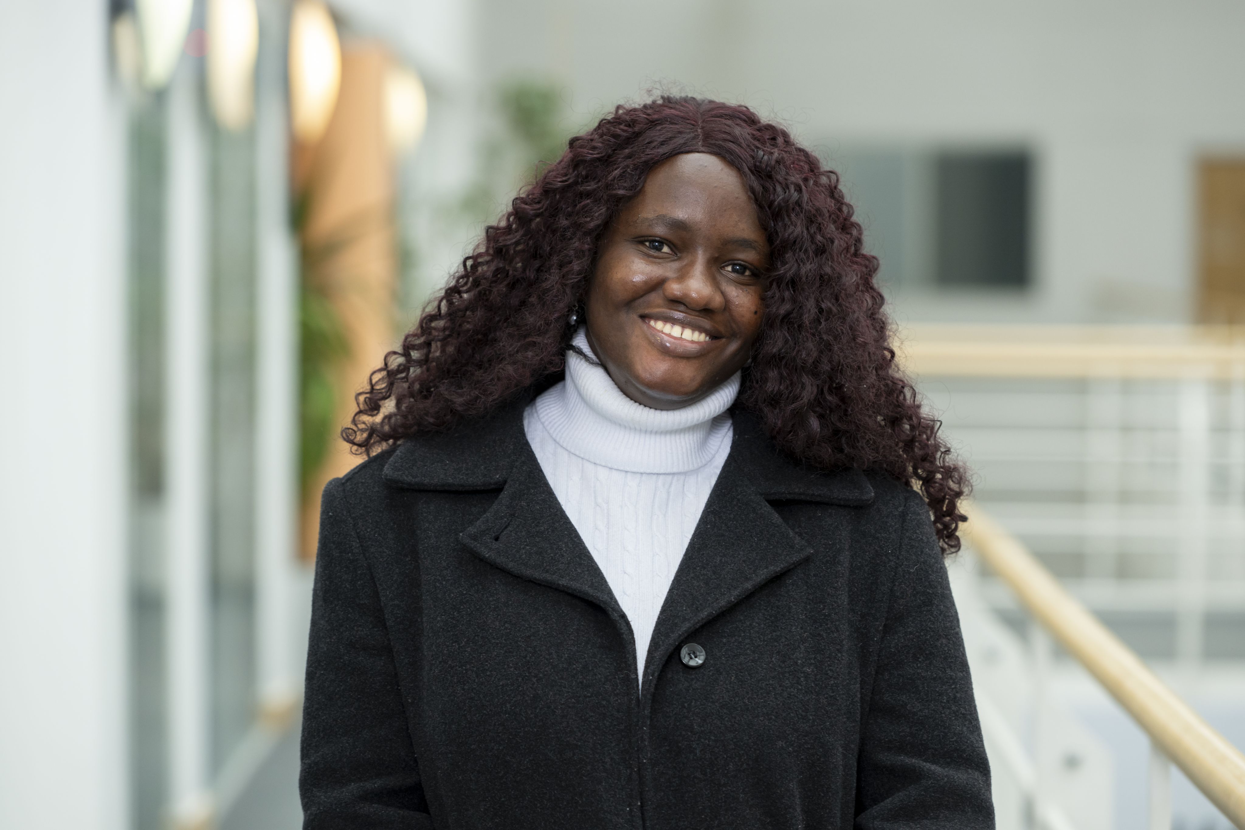Precious Ibe, a Nigerian student at the University of Surrey, smiles at the camera
