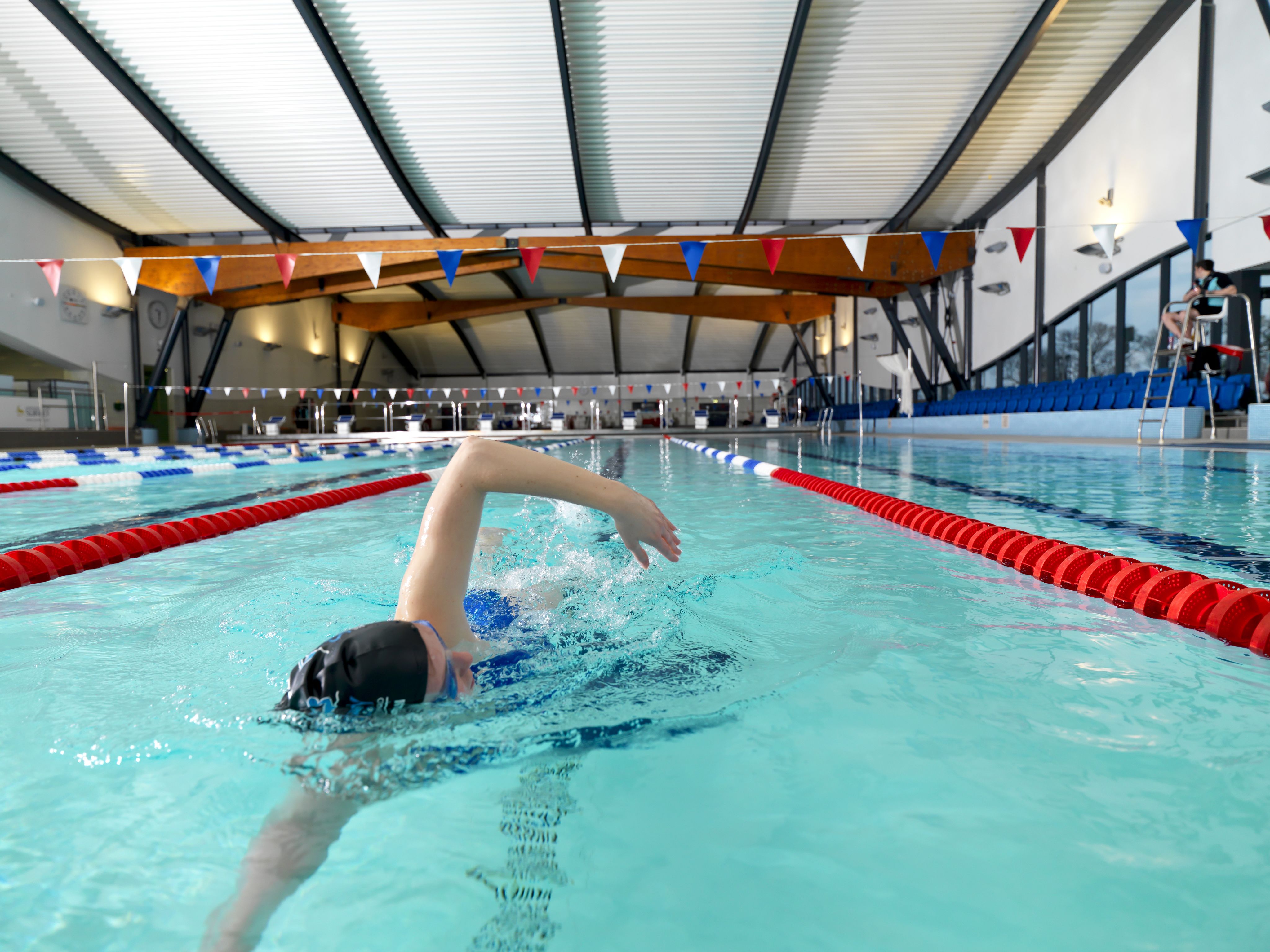 A person swims in the Olympic-sized swimming pool at Surrey Sports Park