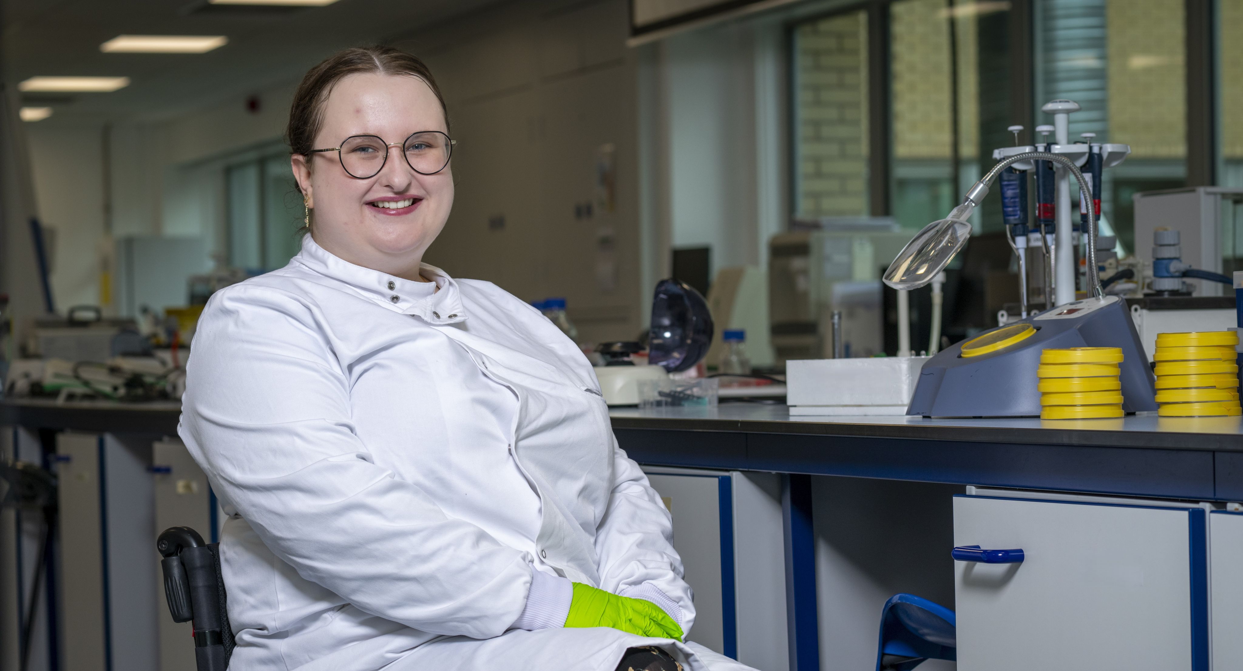 Abi Hayes in a lab coat in the lab