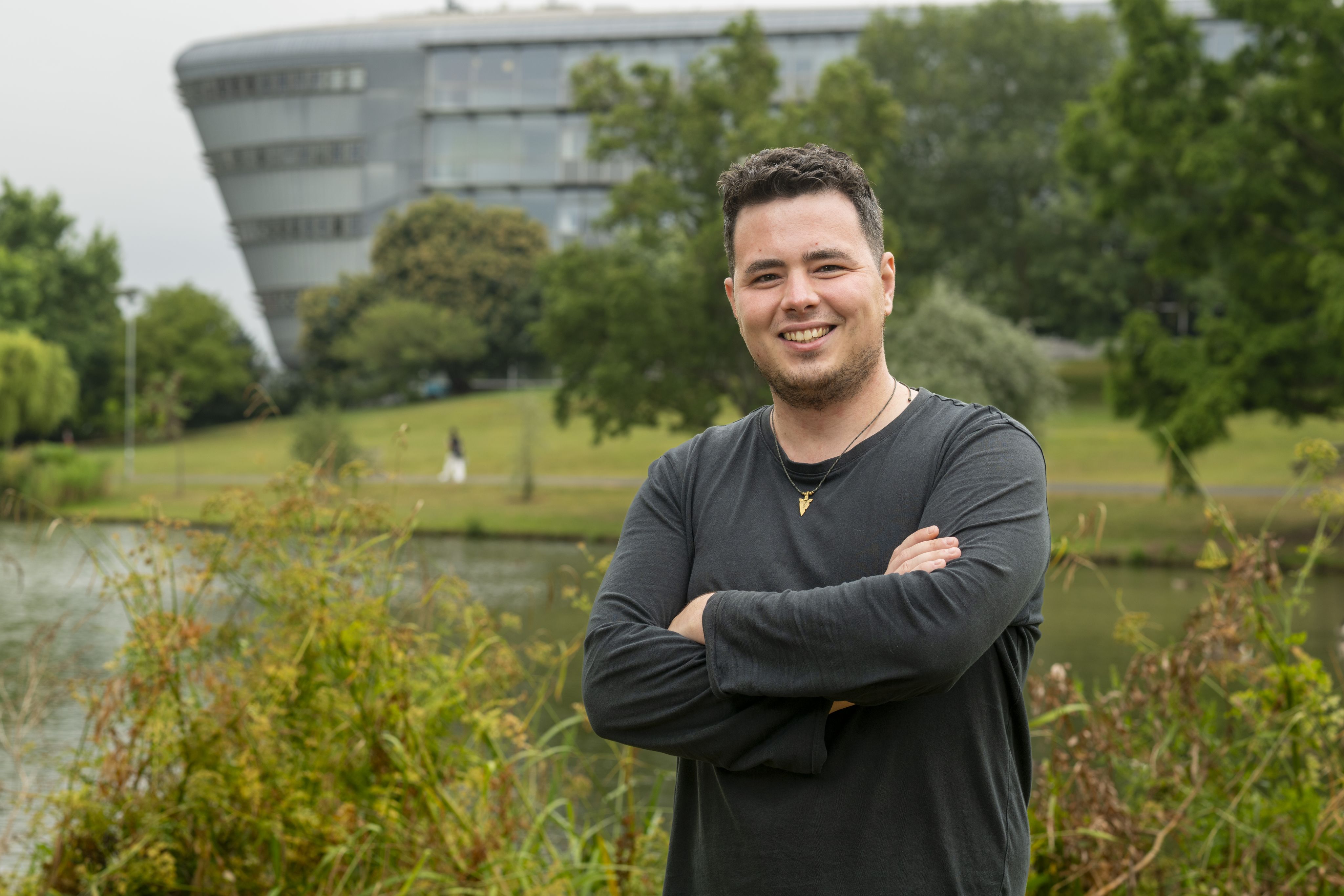 Huw Samuel by the lake on Stag Hill campus