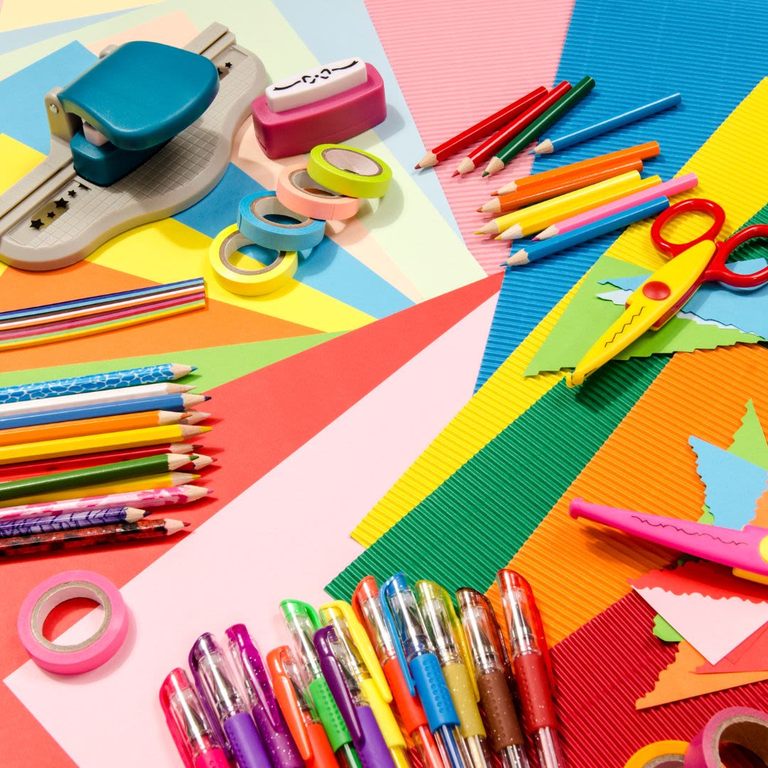 Craft materials including coloured card, pens and scissors