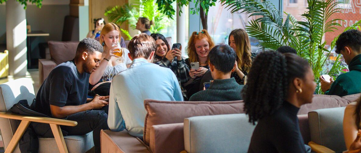Group of students sat in Manor Park Social