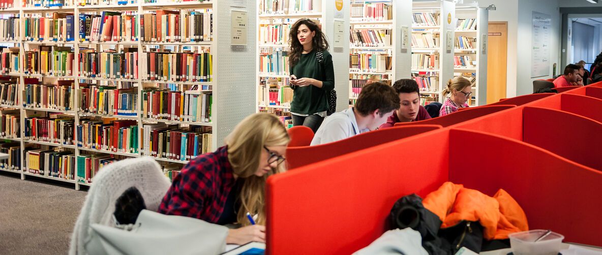 Craft materials including coloured card, pens and scissors