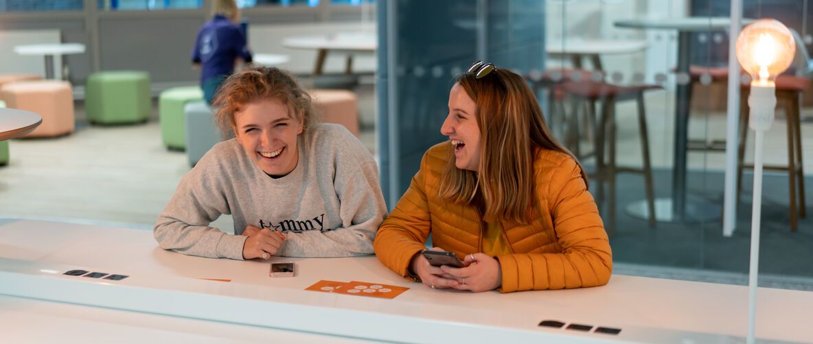 Two students share a joke in MySurrey Hive