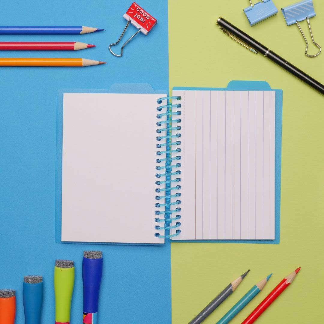Flatlay of a notebook, pens and highlighters