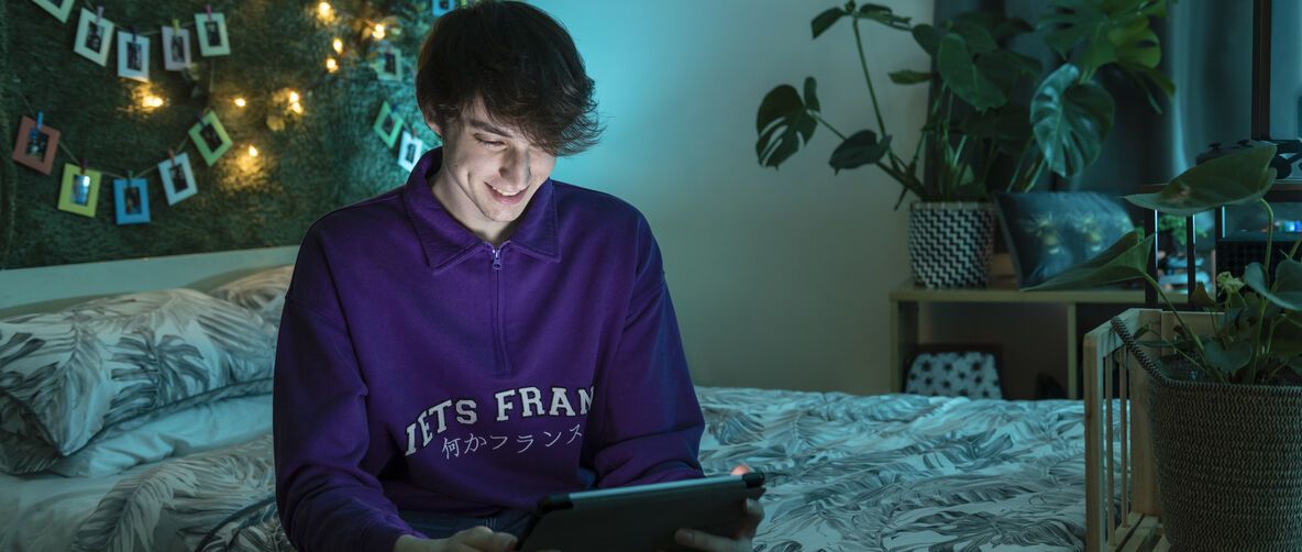 Student in his bedroom in the evening 