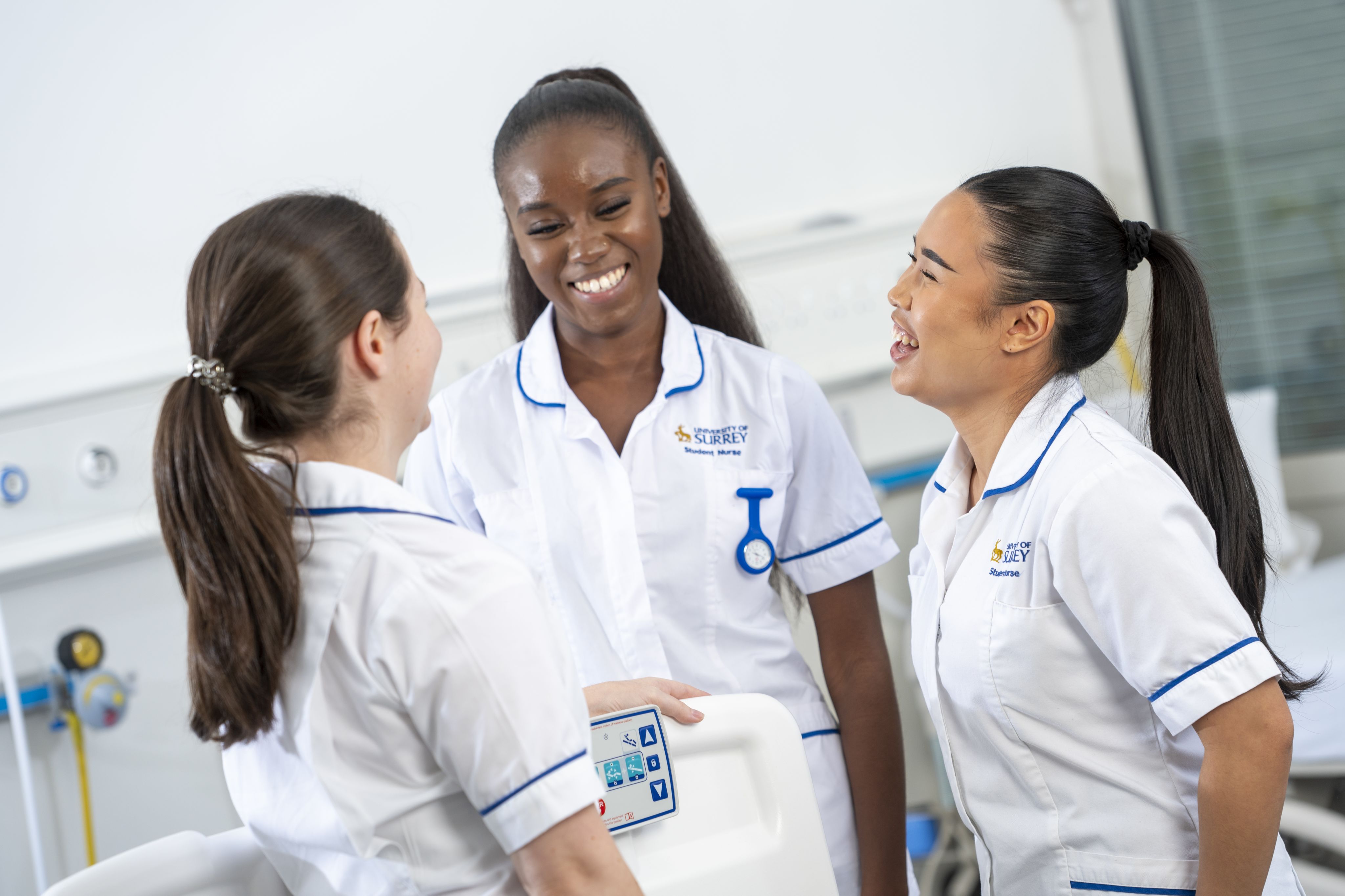 Three Surrey nursing students laughing together