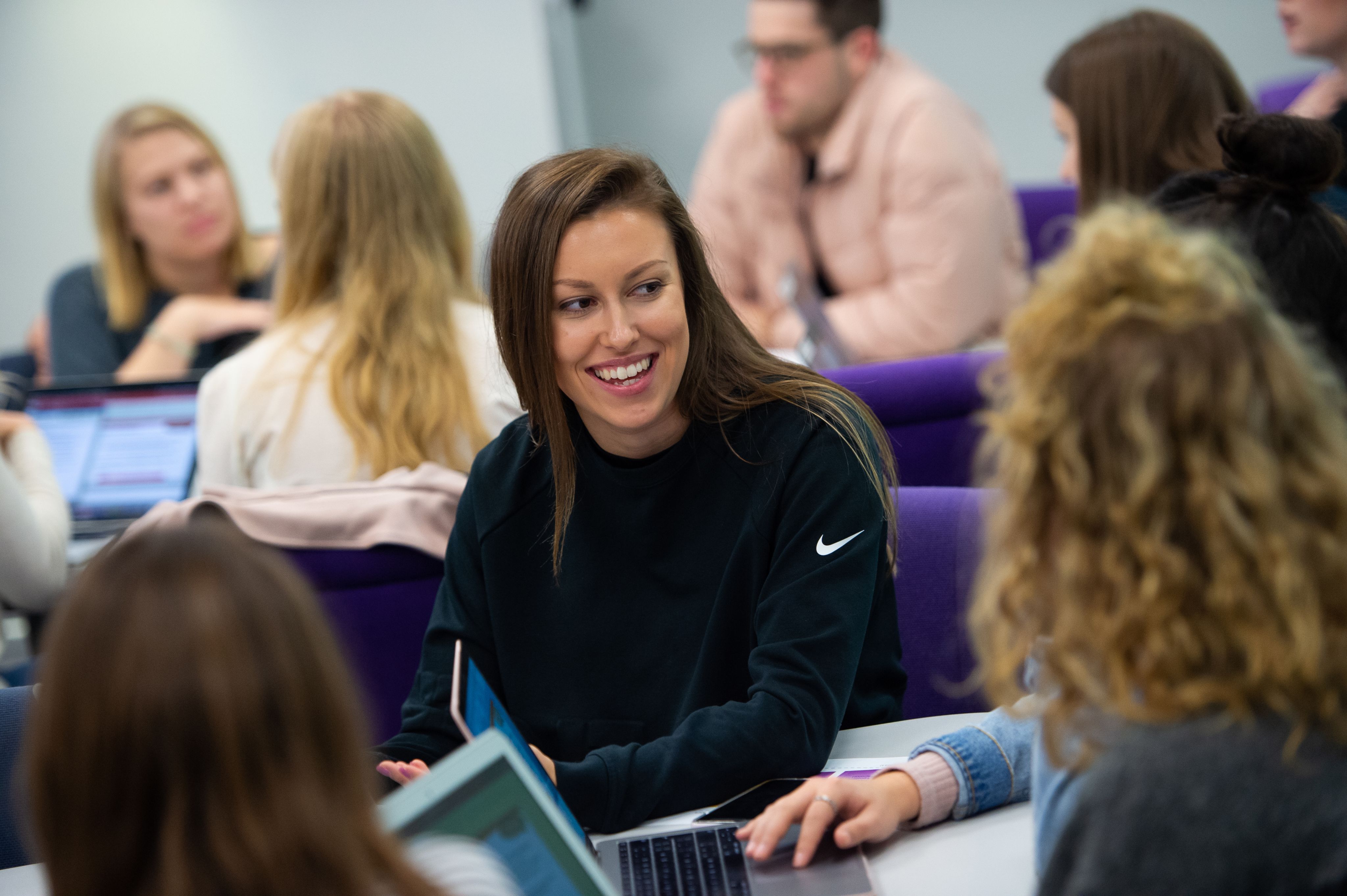 Student smiling in a psychology seminar