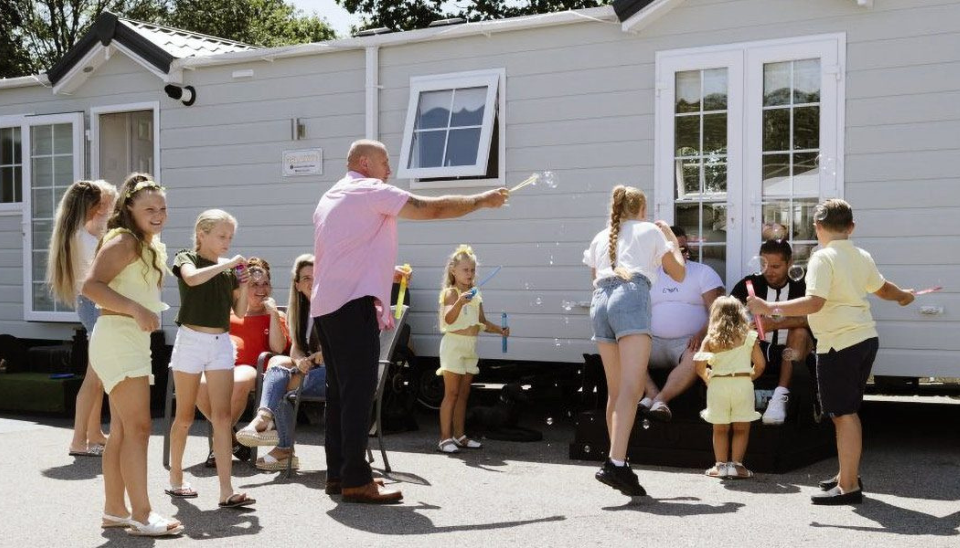 Traveller family playing outside with bubbles
