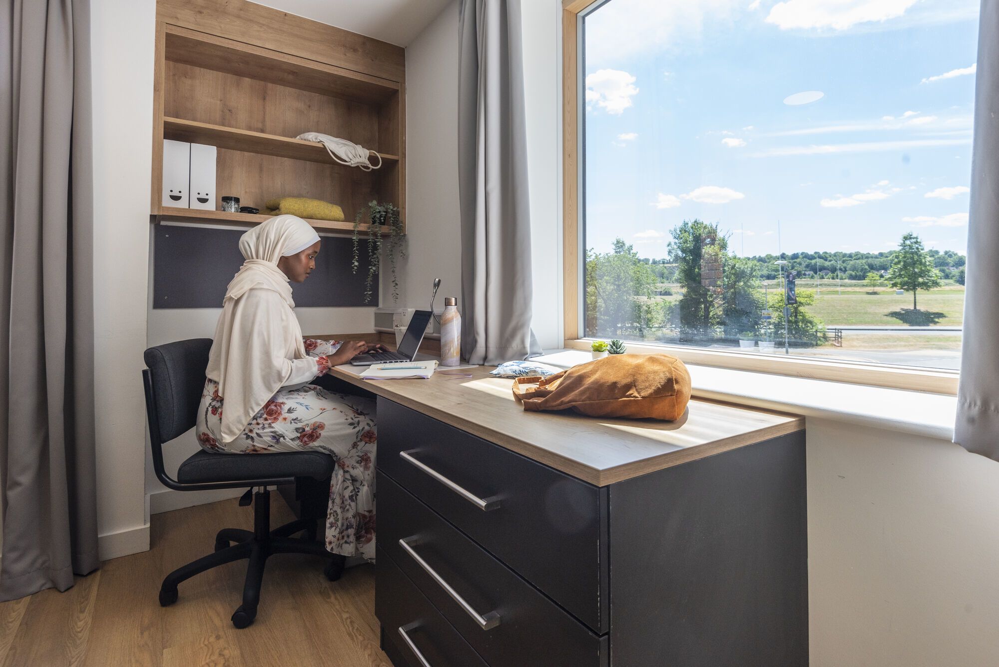 A student works at a laptop in Manor Park accommodation