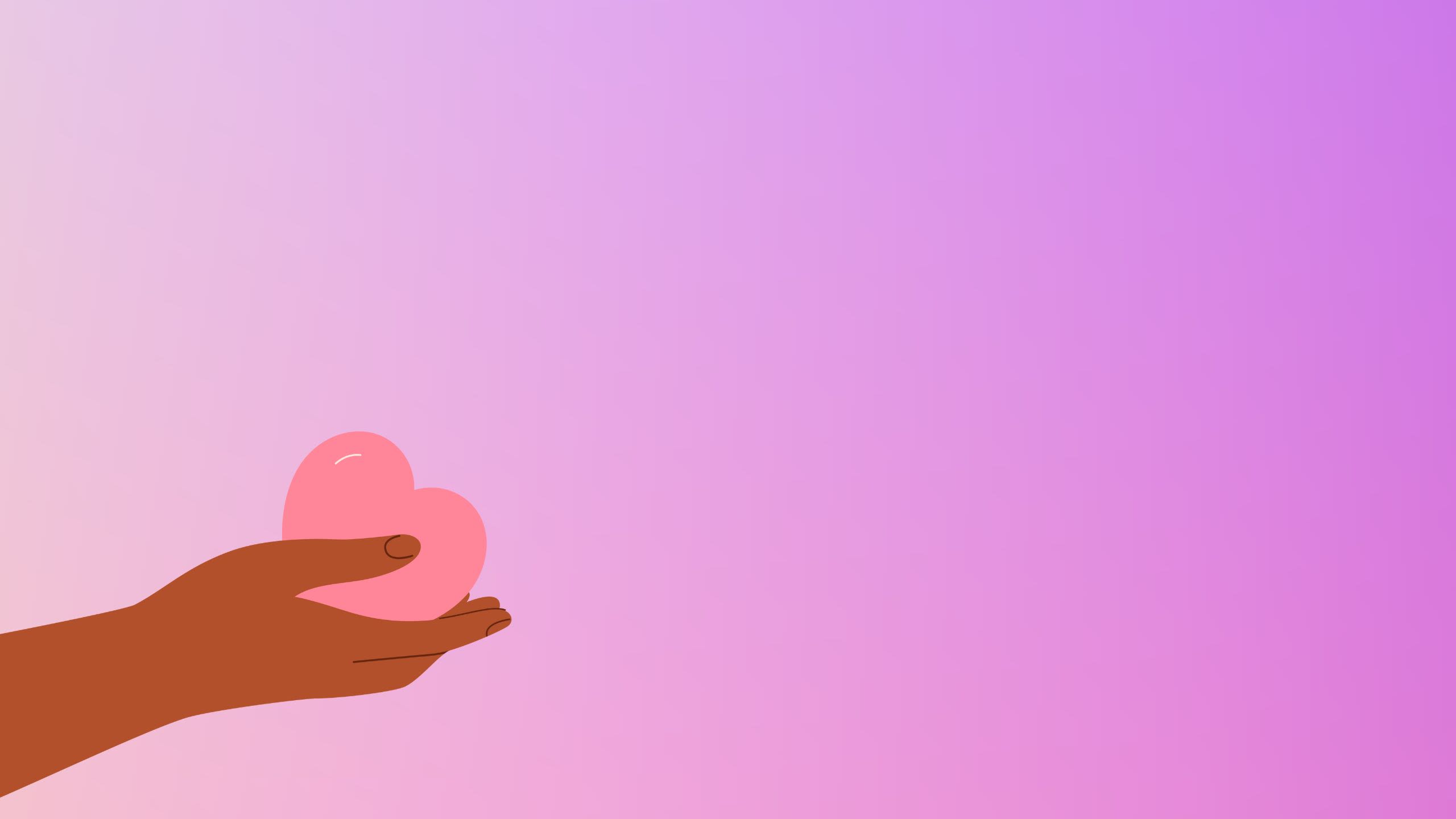 A hand holds a heart on a purple background