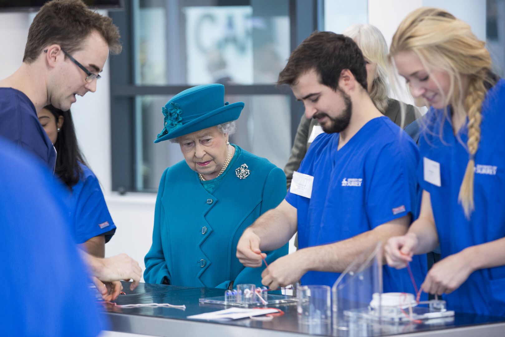 The Queen observing students during 2015 visit. 