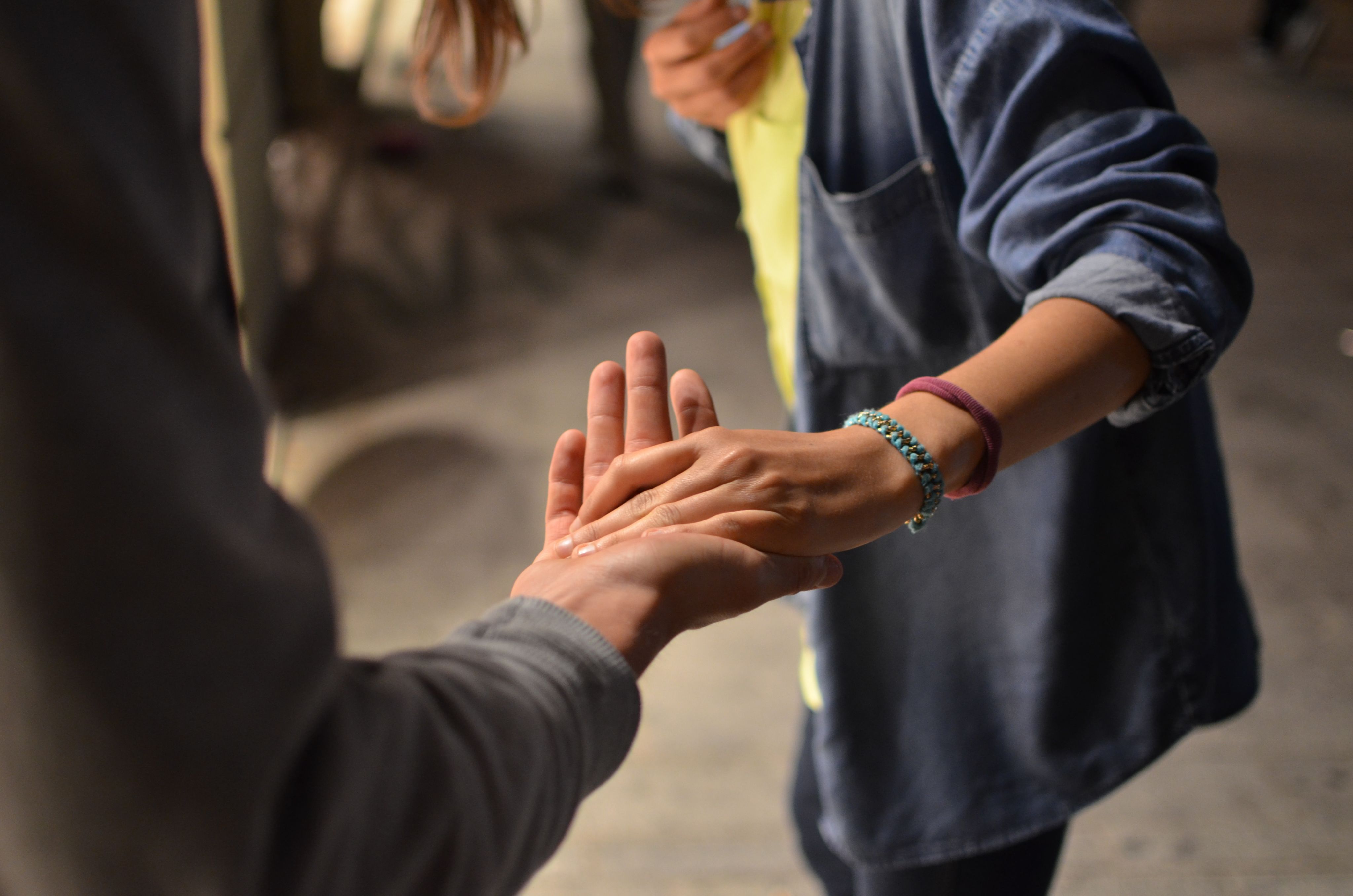 Photo by Rémi Walle on Unsplash - man and woman holding hands on street