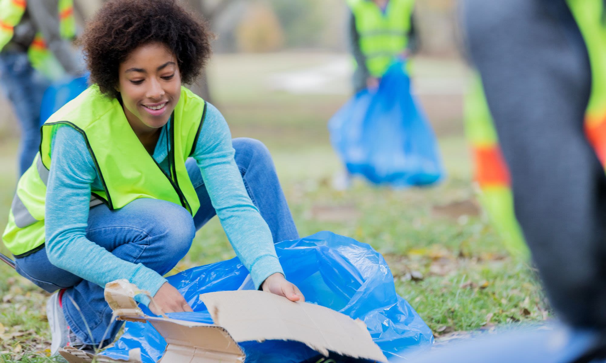 A woman dressed in a high-vis vest takes part in a litter pick