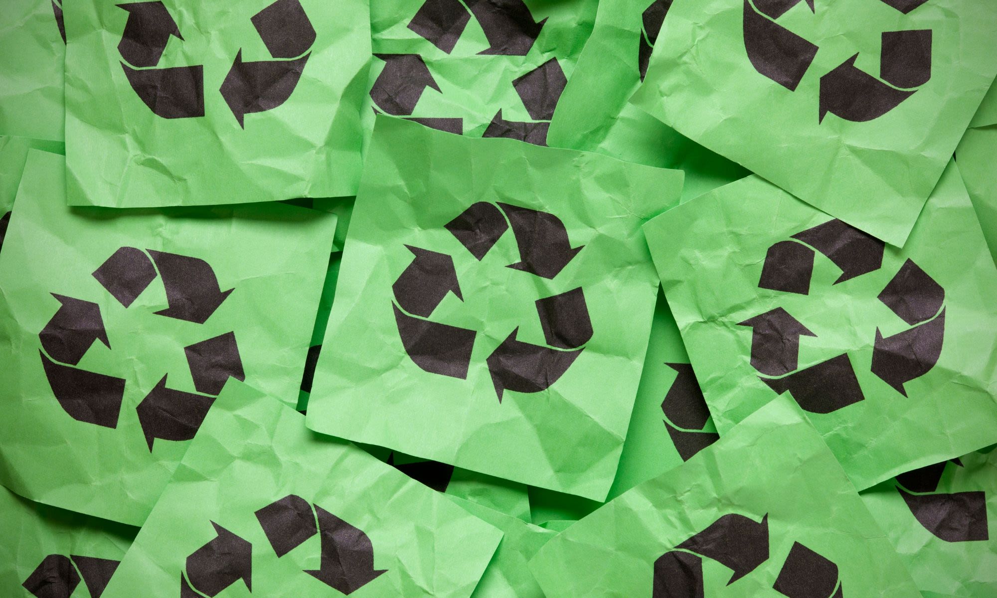Green paper with recycling symbols