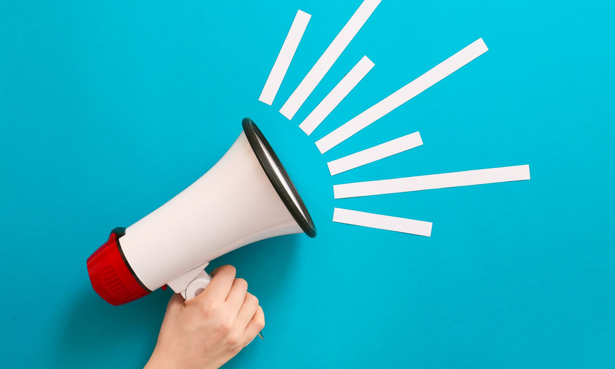 A hand holds a megaphone