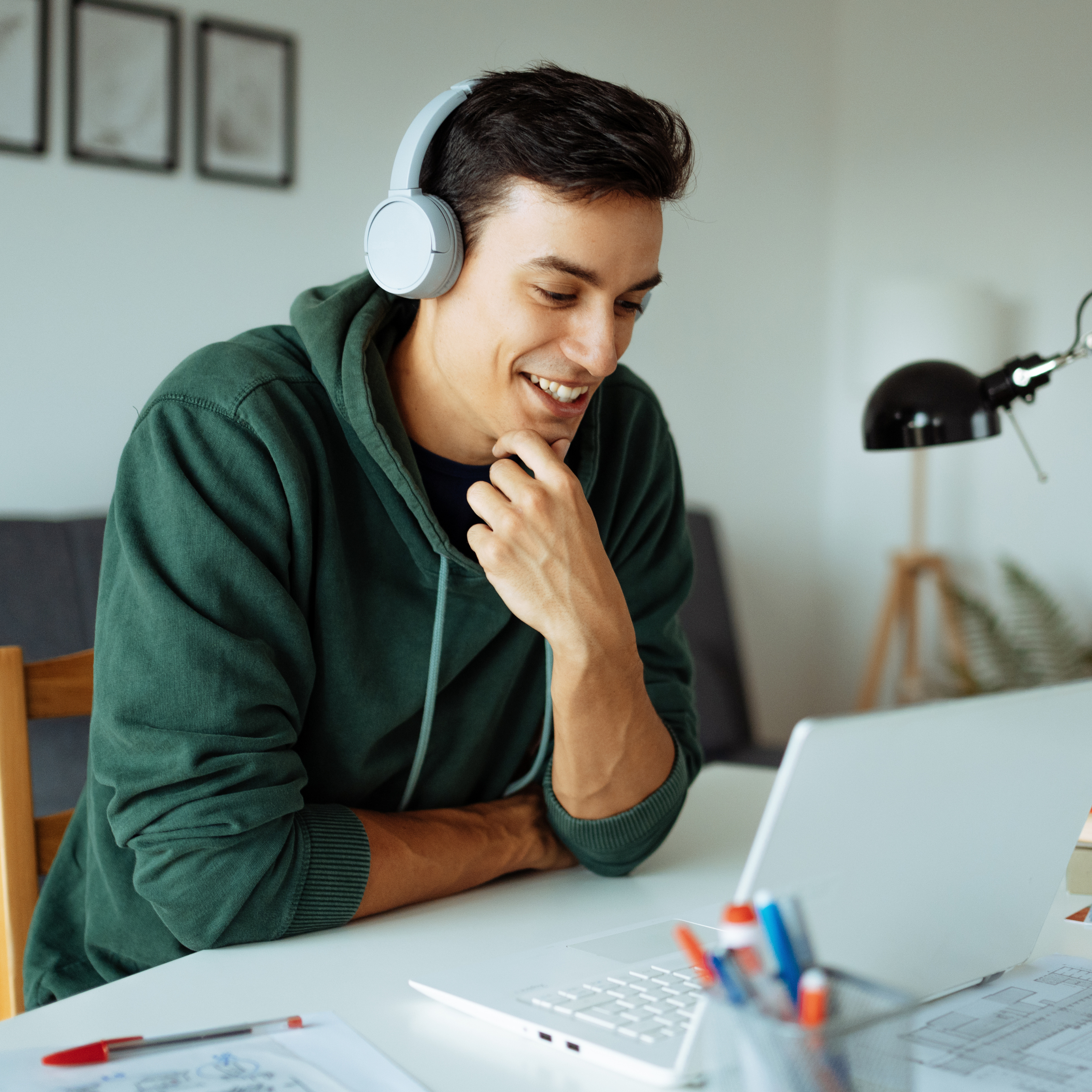 Student with headphones in using their laptop