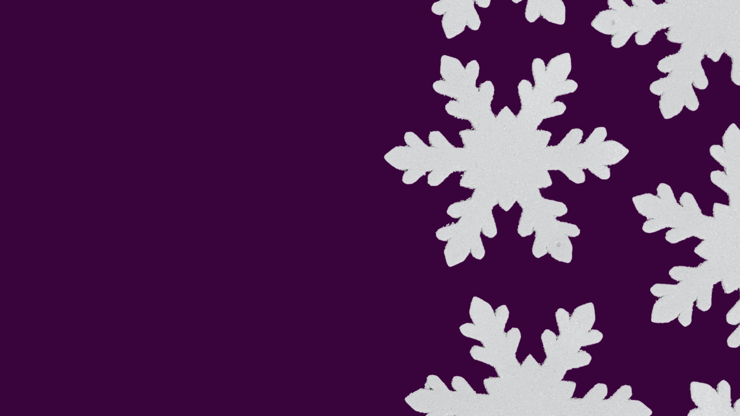 Glitter snowflakes on a dark purple background