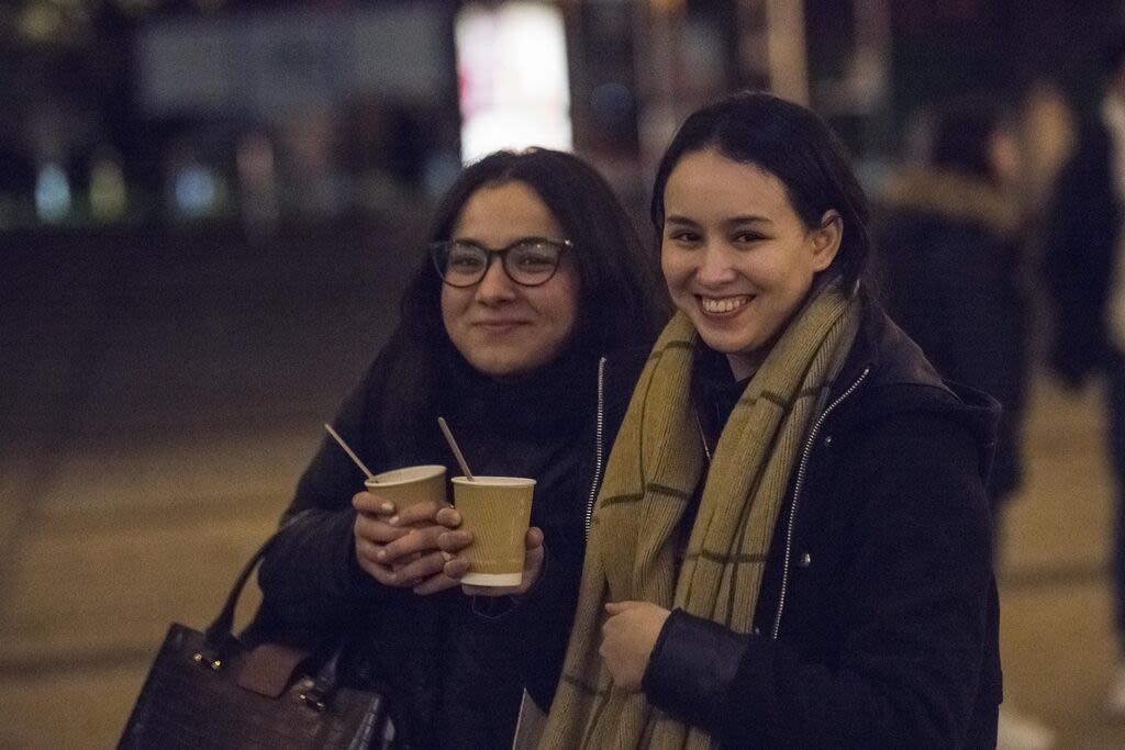 Two students holding hot drinks at the Surrey Switch On