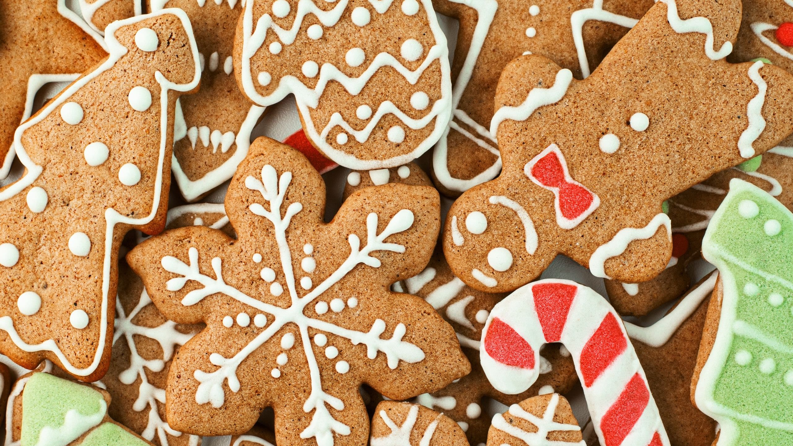 An assortment of festive gingerbread biscuits, decorated with white icing